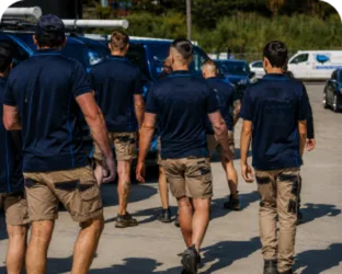 Plumbers walking to their service vans on a Allawah job
